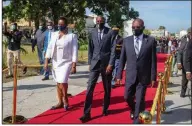  ?? (AP/Dieu Nalio Chery) ?? Haiti’s Prime Minister Joseph Jouthe (right) joins President Jovenel Moise and Moise’s wife, Martine, at an independen­ce ceremony Nov. 18. Jouthe announced his resignatio­n Wednesday.