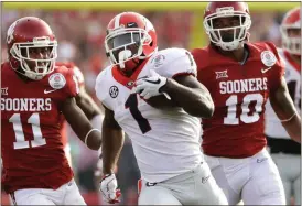  ?? Gregory Bull / AP ?? Georgia running back Sony Michel (1) runs for a touchdown past the Oklahoma defense during the first half of the Rose Bowl in Pasadena, Calif.