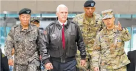  ?? THE ASSOCIATED PRESS ?? U.S. Vice President Mike Pence arrives with U.S. Gen. Vincent Brooks, second from right, commander of the United Nations Command, U.S. Forces Korea and Combined Forces Command, and South Korean Deputy Commander of the Combined Force Command Gen. Leem...