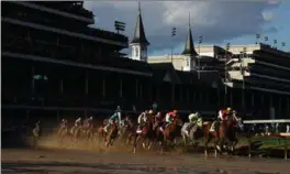  ?? PATRICK SMITH, GETTY IMAGES ?? The field heads into the first turn during the 143rd running of the Kentucky Derby at Churchill Downs Saturday in Louisville, Kentucky.