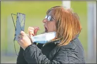  ?? (File Photo/AP/Jon Super) ?? A member of the public swabs herself on the first day of the pilot scheme of mass testing in Liverpool in November. Liverpool was the pilot project for possible weekly testing of the entire population, covering up to 10 million people across England a day.