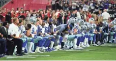  ?? MATT KARTOZIAN, USA TODAY SPORTS ?? Cowboys players, coaches and staff take a knee prior to the national anthem before Monday night’s game vs. the Cardinals.