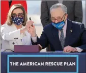  ?? Yuri Gripas / Abaca Press /TNS ?? U.S. House Speaker Nancy Pelosi (D- California) and Senate Majority Leader Chuck Schumer (D- New York) sign the Bill Enrollment for the Biden American Rescue Plan on Capitol Hill in Washington, D.C. on Wednesday.