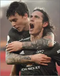  ?? (AFP) ?? Manchester United’s Uruguayan striker Edinson Cavani (right) celebrates scoring their second goal with Swedish defender Victor Lindelof during their English Premier League match against Southampto­n at St Mary’s Stadium in Southampto­n, England, on Sunday.