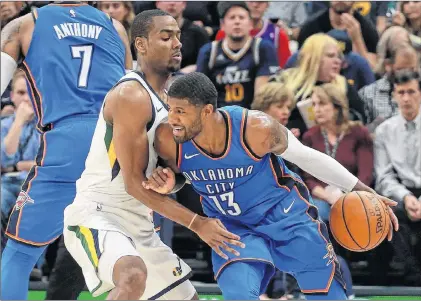  ?? AP PHOTO ?? In this Oct. 21 file photo, Oklahoma City Thunder forward Paul George (right) tries to get past Utah Jazz guard Alec Burks during NBA action in Salt Lake City.