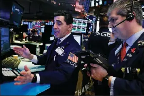  ?? AP/RICHARD DREW ?? Specialist Peter Mazza (left) and trader John Panin work Thursday on the floor of the New York Stock Exchange.