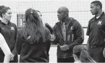  ??  ?? Derrick Brooks, middle, talks to his Mount Saint Vincent University players during a match.