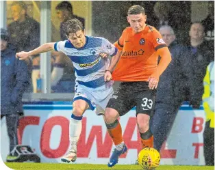  ??  ?? United’s Fraser Aird struggles to evade the clutches of the Morton defence