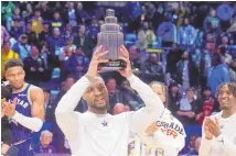  ?? ASSOCIATED PRESS ?? Milwaukee Bucks guard Damian Lillard lifts the MVP trophy after the East defeated the West 211-186 in the NBA All-Star basketball game in Indianapol­is.