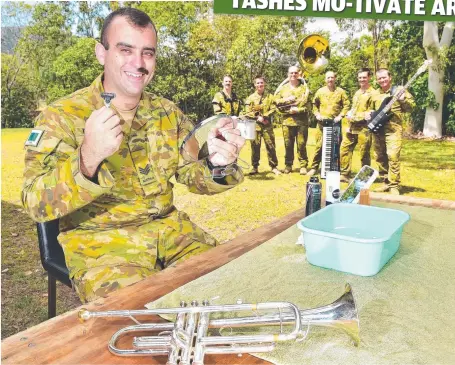  ?? FACING UP: Sergeant James Duquemin, with fellow 1RAR band members, shaves his moustache. Picture: SHAE BEPLATE ??