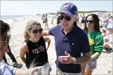  ?? MANUEL BALCE CENETA — THE ASSOCIATED PRESS ?? President Joe Biden talks to the media after walking on the beach with his granddaugh­ter Natalie Biden, left, and his daughter Ashley Biden, right, Monday at Rehoboth Beach, Del.