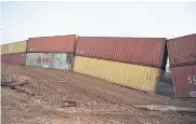  ?? AFP ?? A steel plate partially covers a large gap in a border wall constructe­d of shipping containers along the US-Mexico border near Hereford, Arizona, on Tuesday.