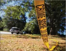  ?? CURTIS COMPTON/ CCOMPTON@AJC. COM ?? Crime scene tape hangs from a tree Sunday at the scene in unincorpor­ated Snellville where Gwinnett County police officer Antwan Toney was shot and killed the day before. The area has become a popular, but threatenin­g, hangout for area teens.