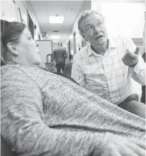  ??  ?? Turnbull chats with Dolores Carroll at the Shepherds of Good Hope during the doctor’s rounds Thursday with Ottawa Inner City Health, an organizati­on he helped found 15 years ago.