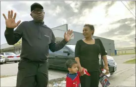  ??  ?? In this Tuesday, Dec. 10, 2019, Rapper turned political candidate, Brad “Scarface” Jordan, left, visits with voter Michele Lemon and her son outside of an early voting location in the Sunnyside neighborho­od of Houston, Texas.