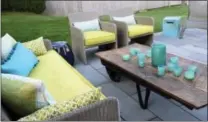  ?? KRISTINA CRESTIN VIA AP ?? This undated photo provided by Kristina Crestin shows an outdoor space in Essex, Mass., designed by Crestin. One key to enjoying your outdoor living space in chilly fall weather: Sofas and chairs with deep, padded seats. In this backyard patio deep...