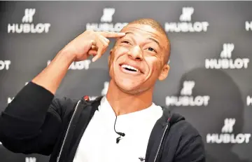  ?? — AFP photo ?? France’s forward Kylian MBappe poses during a photo session after an interview with AFP in which he announced the formalizat­ion of his Ambassador­ship with the Swiss luxury watchmaker Hublot on November 8, 2018.