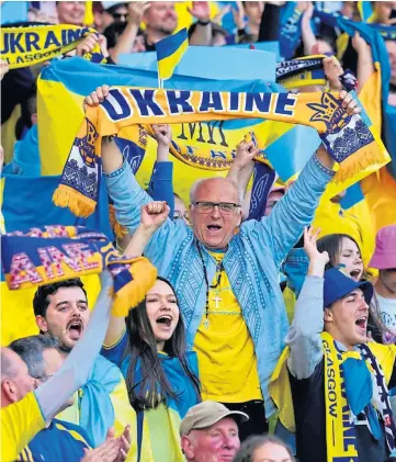  ?? ?? JOY: Ukraine fans celebrate skelping Scotland in a World Cup qualifier at Hampden.