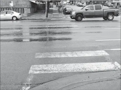  ?? ERIN POTTIE/CAPE BRETON POST ?? A motorist goes through a faded crosswalk located on George Street across from Centre 200 in Sydney.