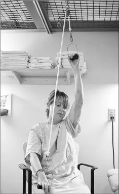  ??  ?? Tatiana Dimion performs physiother­apy at St. John's Rehab Hospital in Toronto.