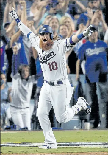  ?? GETTY IMAGES ?? Dodgers’ Justin Turner celebrates after hitting a walk-off three-run home run in the ninth inning to defeat the Chicago Cubs 4-1 in Game 2 of the NLCS in Los Angeles last night.