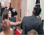  ??  ?? U.S. President Donald Trump points as a White House aide tries to take away a microphone from CNN journalist Jim Acosta during Wednesday’s news conference.