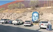  ?? [ANITA SNOW/THE ASSOCIATED PRESS] ?? In this Dec. 4 photo, a portrait of 16-year-old Mexican youth Jose Antonio Elena Rodriguez, who was shot and killed in Nogales, Sonora, Mexico, is displayed on the street where he was killed that runs parallel with the U.S. border.