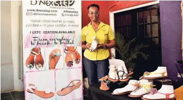  ?? ERROL CROSBY ?? Dorrette Watson, owner of D’Nex Step Sandals and Accessorie­s, showing off her creations at the Reggae Sumfest launch held yesterday at Downsound Records on Belmont Road.