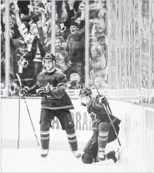  ?? DARRYL DYCK THE CANADIAN PRESS ?? MacKenzie Entwistle, right, who went from the Hamilton Bulldogs to the Guelph Storm, was one of six Team Canada players traded in the CHL.