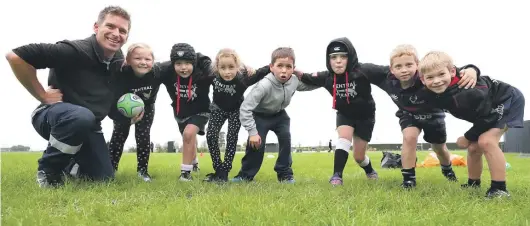  ?? ROBYN EDIE/STUFF ?? Members of the Central Pirates C-grade black team at their home ground. From left: coach Greg Berryman, 8-year-olds Hailey Thomson and Jake Miller, 7-year-olds Carys Dawson and Chase Spence, Kayla Miller and Beau Blair, both aged 8, and Luke Berryman, 7.