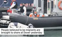  ??  ?? People believed to be migrants are brought to shore at Dover yesterday