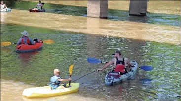  ?? Spencer Lahr / Rome News-Tribune ?? Chuck Barker pulls his son Thomas Barker, 3, along the Etowah River on Saturday to start Coosa River Basin Initiative’s Big Float.