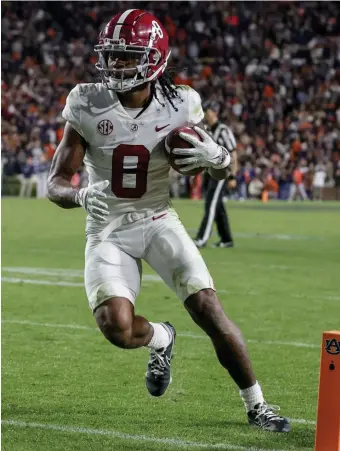  ?? Ap FiLE pHOTOS ?? SECOND THOUGHTS: The Patriots could target Alabama wide receiver John Metchie III or UCLA offensive lineman Sean Rhyan, left, in the draft today.