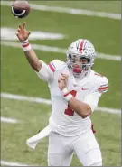  ?? Al Goldis / Associated Press ?? Ohio State QB Justin Fields threw for a pair of touchdowns and ran for two more against Michigan State in East Lansing on Saturday.