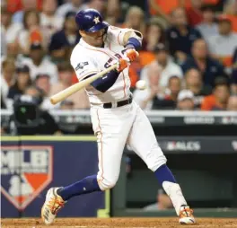  ?? BOB LEVEY/GETTY IMAGES ?? Carlos Correa smacks a walk-off home run in the 11th inning Sunday to boost the Astros past the Yankees in Game 2 of the ALCS in Houston.