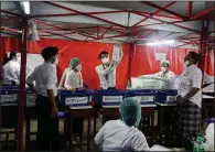  ?? (AP/Thein Zaw) ?? Election officials count ballots Sunday at a polling station in Rangoon, Burma.