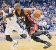  ?? John Raoux/Associated Press ?? Heat guard Dwyane Wade goes to the basket past the Magic’s Victor Oladipo in Orlando, Fla., in 2015