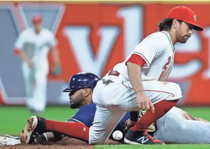  ?? ASSOCIATED PRESS ?? Jonathan Villar steals second as Reds shortstop Alex Blandino loses the ball in the sixth inning.