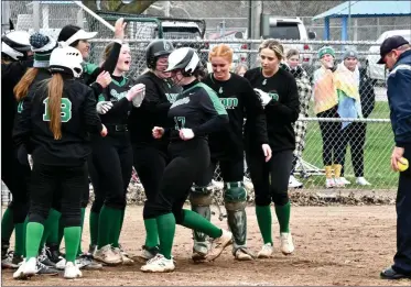  ?? PILOT PHOTO/RON HARAMIA ?? Bremen’s Gretchen Willis (17) is mobbed by her teammates after hitting a grand slam, her second HR of the game Wednesday.