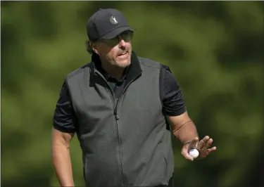  ?? ALASTAIR GRANT — THE ASSOCIATED PRESS ?? Phil Mickelson of the United States reacts to the crowd after putting on the 15th green during the final round of the inaugural LIV Golf Invitation­al at the Centurion Club in St Albans, England, Saturday, June 11, 2022.