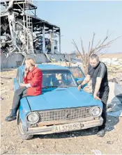  ?? ?? A woman and her husband next to the remains of a food factory which was destroyed in Brovary near Kyiv