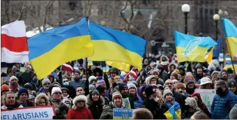  ?? NANCY LANE — BOSTON HERALD ?? People wave Ukrainian flags at a rally in Copley Sq. in support of the Ukrainian people on Sunday.