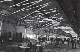  ?? ERIC RISBERG/AP ?? People chat in a hall filled with colored lights at F8 in 2016.