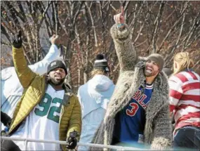  ?? GENE WALSH — DIGITAL FIRST MEDIA ?? Eagles players Fletcher Cox and Chris Long wave to fans during the team’s Victory Parade along Broad Street Thursday.