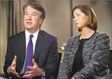  ?? Jacquelyn Martin Associated Press ?? “I WAS FOCUSED on academics and athletics, going to church every Sunday,” Brett Kavanaugh, with wife Ashley Estes Kavanaugh, said of his youth. But he has shared stories of heavy drinking in the past.