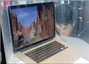  ?? Paul Sakuma AP ?? MacBook Pro: Attendee checks it out at Apple conference.