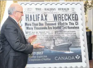  ?? CP PHOTO ?? Nova Scotia Lt.-Gov. Arthur J. LeBlanc applauds as he unveils the Canada Post Halifax Explosion commemorat­ive stamp in Halifax on Monday.