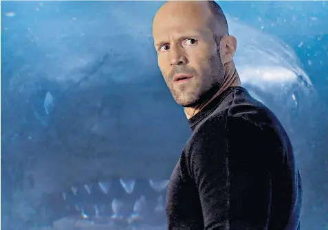  ??  ?? Face off: Jason Statham takes on a prehistori­c shark in The Meg