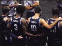  ?? Maddie Meyer / Getty Images ?? Teammates of the Villanova Wildcats wrap their arms around each other in the huddle during a timeout in a game against Boston College during the 2K Empire Classic at Mohegan Sun Arena on Nov. 25.