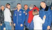  ?? AFP ?? Astronaut Nick Hague (left) and cosmonaut Alexey Ovchinin with family members at the Krayniy Airport in Baikonur.